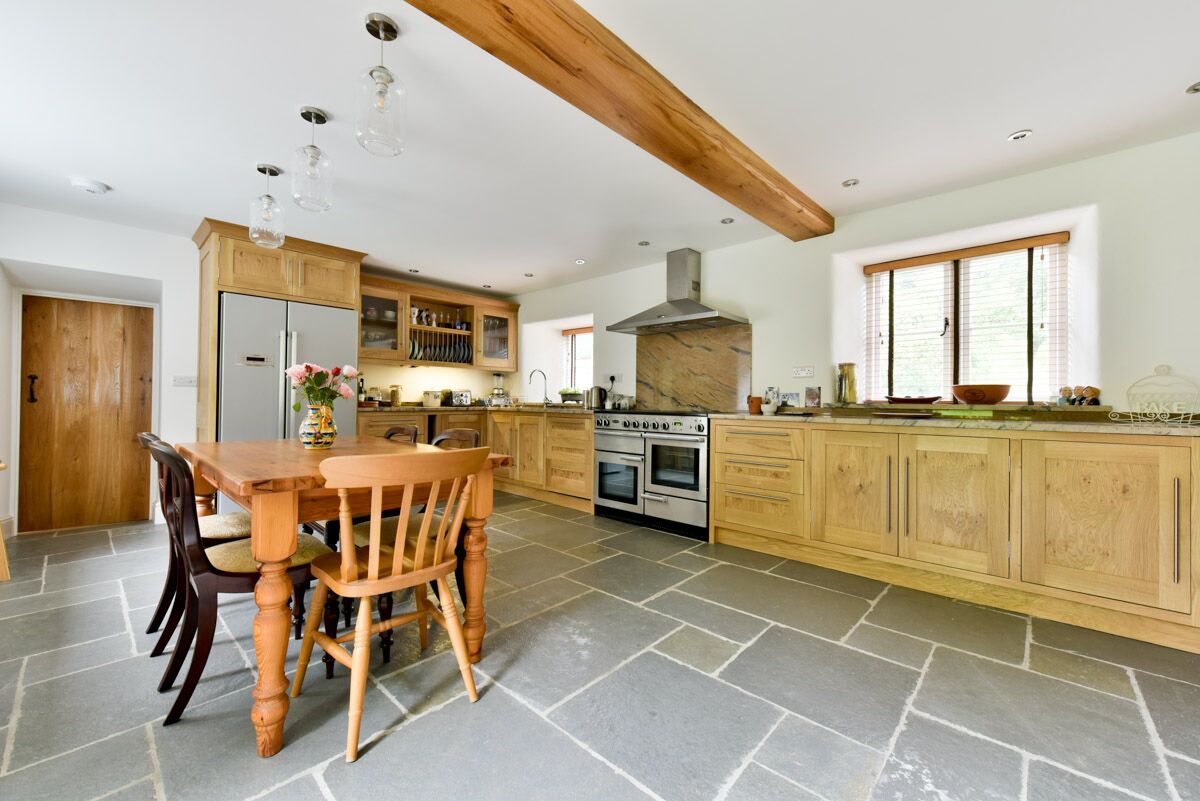 White Kitchen bespoke timber cabinets with black worktop and white walls