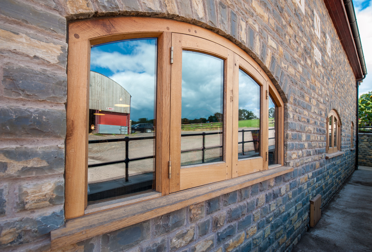 Curved bespoke timber framed window fitted in a property in somerset near Bristol